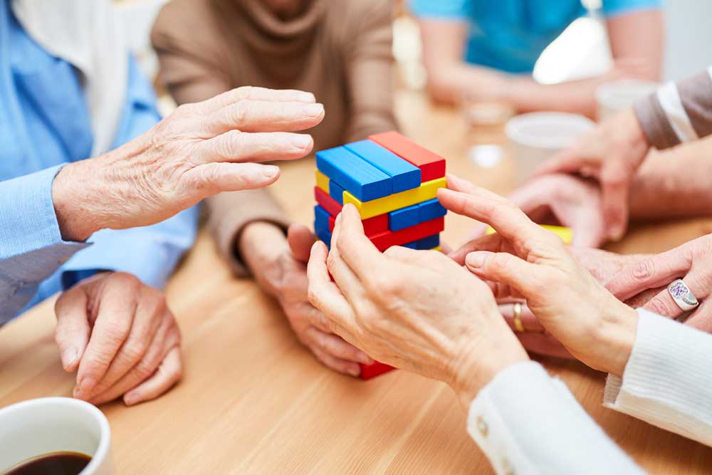 elderly people playing jenga