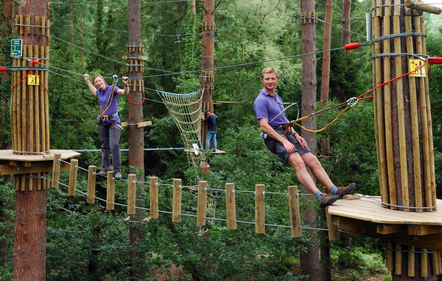 Go Ape - two people on a high wire assault course
